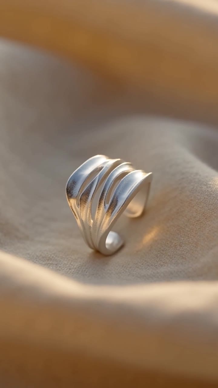 Product photo of a silver ring on linen